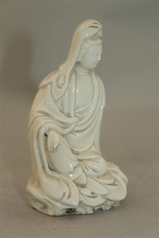 A Chinese blanc de chine seated figure of Guanyin, Dehua, 18th / 19th century, 11cm, losses to fingers